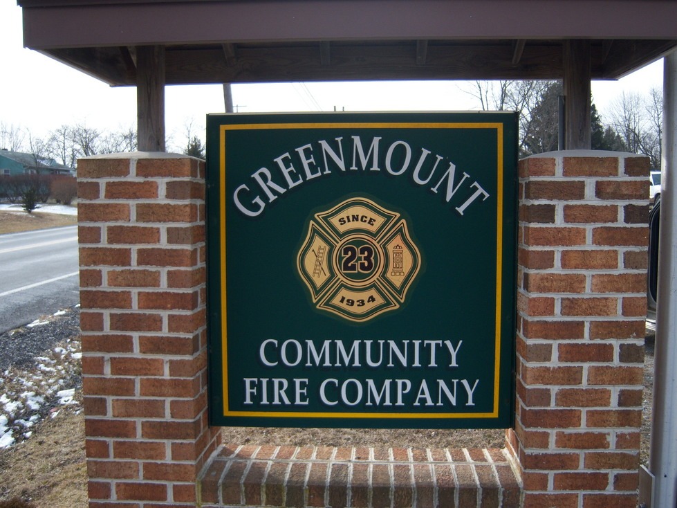 Green sign reads "Greenmount Community Fire Company," with a badge logo and "Since 1934" in the center.